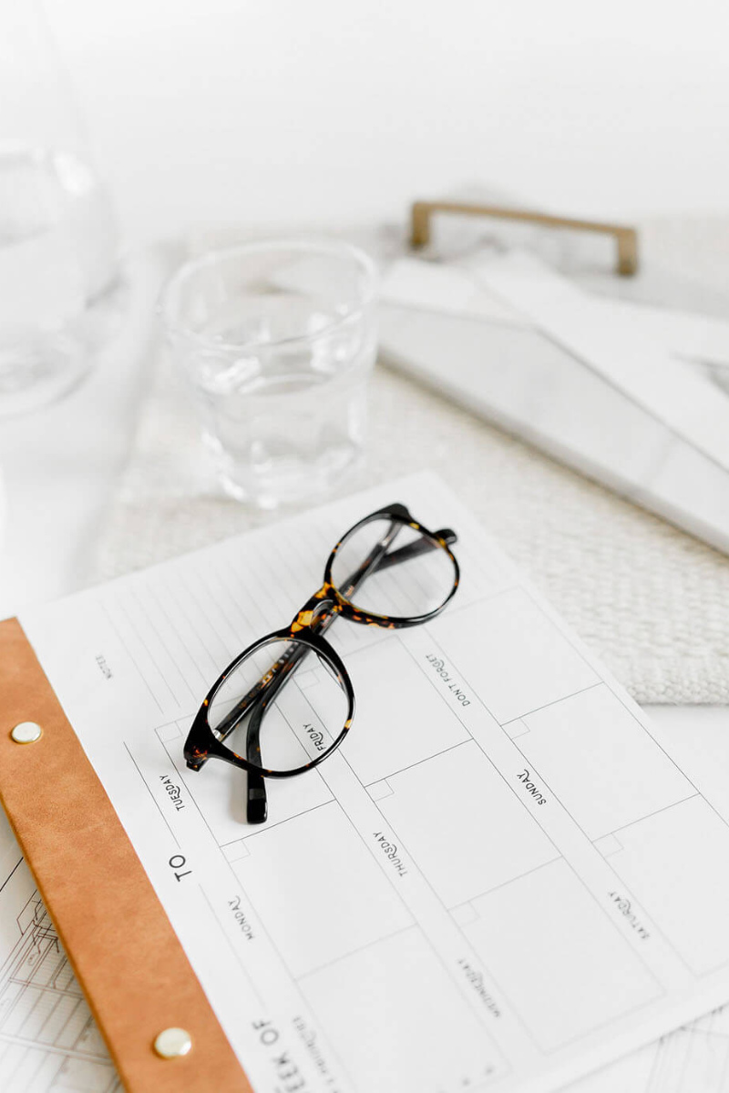 feminine specs laying on a calendar