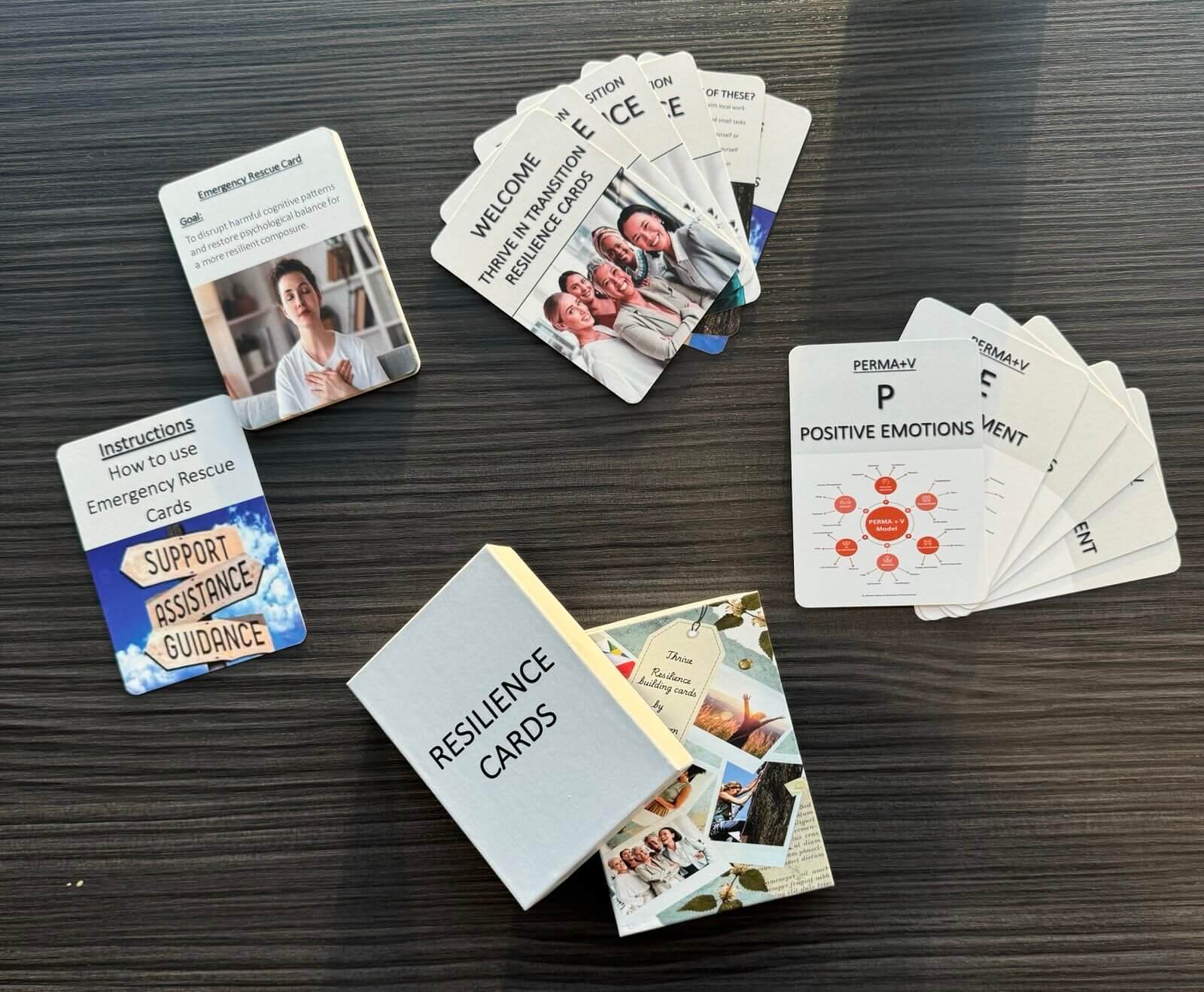 Reliance cards presented on a dark table with the cards fanned out around the box