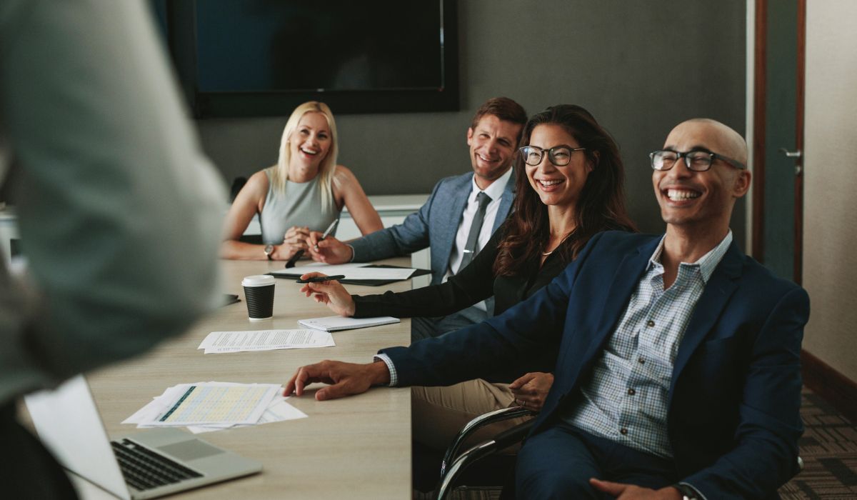 Why the Human Behind the Leader Matters, Happy people in a business meeting